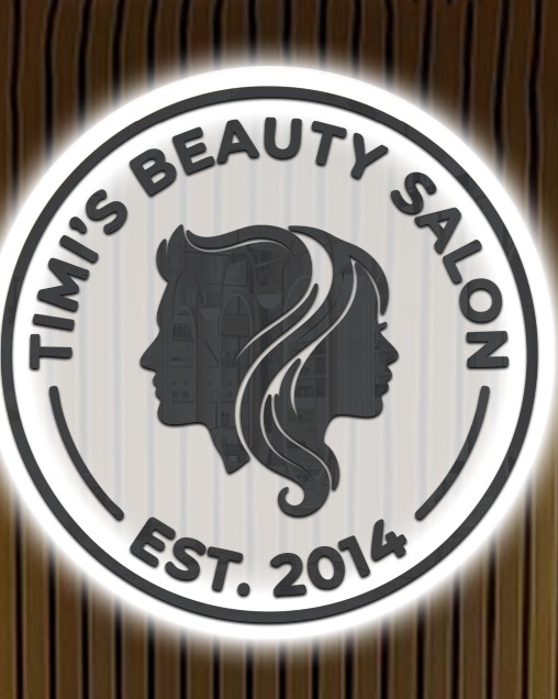 Illuminated Timi's Beauty Salon EST. 2014 sign on wooden accent wall